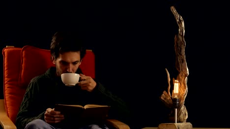 man-drinking-tea-next-to-the-lamp