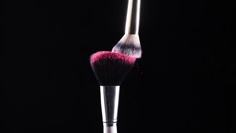 two-make-up-brushes-collide-creating-an-explosion-of-colored-powder-2