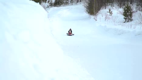 Girl-and-Woman-Riding-Fast-on-a-Sledding-Tubing