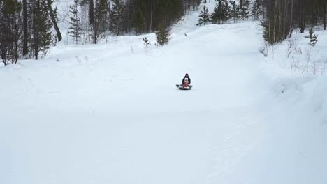 Woman-and-Little-Girl-Sliding-Down-on-a-Tube