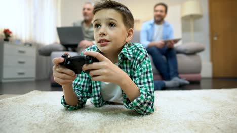 Preteen-boy-playing-video-game,-dad-and-granddad-smiling,-leisure-and-hobby