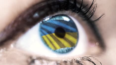 Frau-blaues-Auge-in-Nahaufnahme-mit-der-Flagge-der-Ukraine-in-Iris-mit-Windbewegung.-Videokonzept