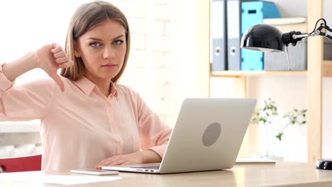 Thumbs-Down-by-Creative-Woman--in-Office