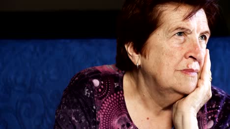 Pensive,worried-mature-woman-at-home,-close-up.