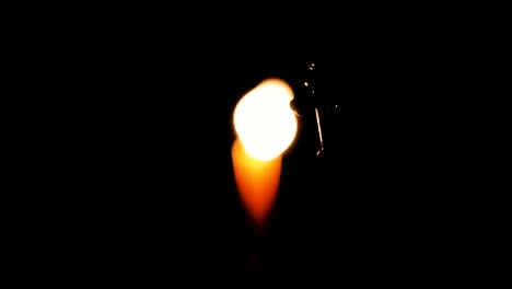 Cross-on-the-background-of-a-burning-candle-in-the-church