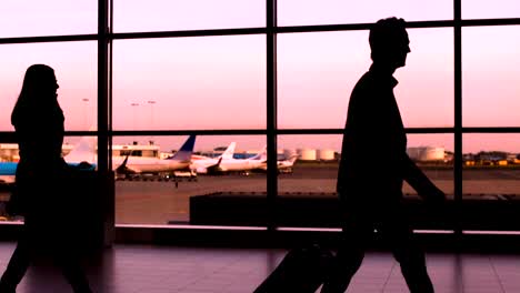 Crowd-silhouette-walking-in-airport,-business-people-and-tourists-hurry-to-plane