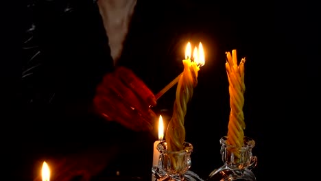 Woman-with-blood-hands-lights-candles