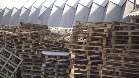 Wooden-pallets-stacked-in-the-warehouse.-Cargo-delivery-on-pallets