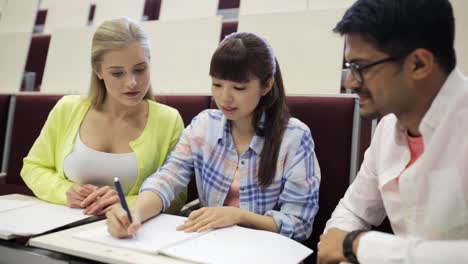 group-of-students-with-notebooks-in-lecture-hall