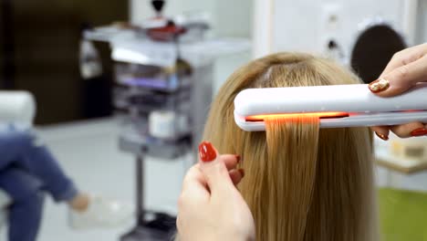 Haidresser-straighten-hair-with-hair-iron