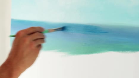 painter-paints-picture-on-blank-canvas,-close-up