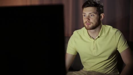 young-man-watching-tv-at-night