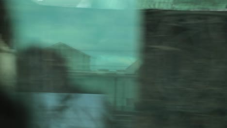 Urban-city-landscape-seen-from-a-moving-train-in-motion