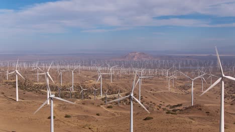 Aerial-view-of-giant-wind-turbine-field-shot-from-above-looking-down-creating-clean-renewable-energy