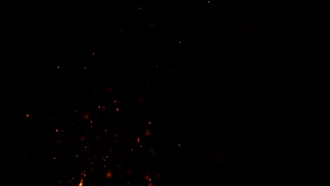 high-speed-shot-of-fire-flames-and-glowing-ash-particles-on-black-background