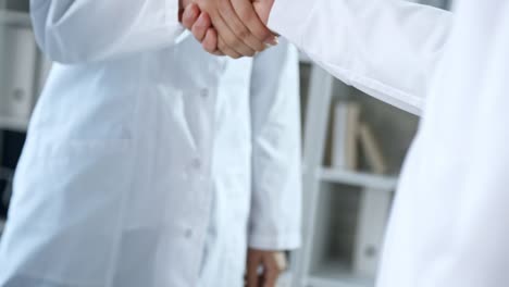 Hands-of-Multi-Ethnic-Doctors-at-Meeting