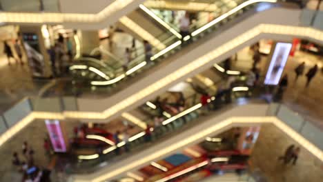 People-Using-Escalator-In-Shopping-Mall-Centre