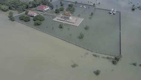 Aerial-view-:-fly-up-revealing-a-pagoda-is-surrounded-by-floodwaters