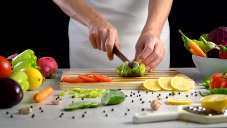 Chef-is-cutting-broccoli-in-the-kitchen