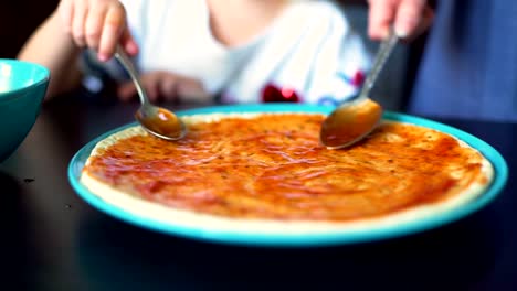 Mother-and-Daughter-Putting-Tomate-Sauce