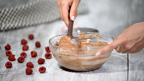 Bowl-of-chocolate-batter-being-stirred-around.-The-process-of-making-chocolate-batter.