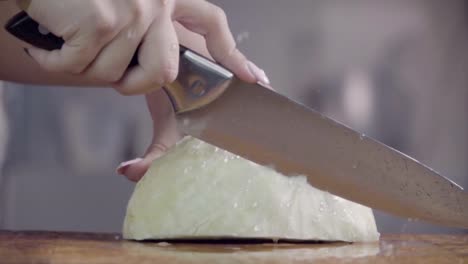 Cutting-cabbage-with-knife-on-the-wood.-Slow-motion