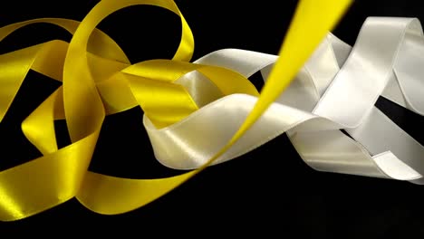 Satin-ribbon-on-a-black-background.-Slow-motion.