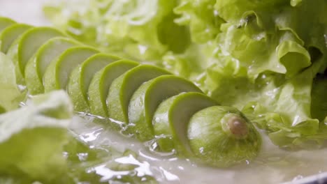 Falling-of-sliced-zucchini-into-the-wet-table.-Slow-motion-240-fps