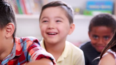 Elementare-Schüler-zuhören-und-Lachen-in-der-Klasse