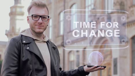 Smart-young-man-with-glasses-shows-a-conceptual-hologram-Time-for-change