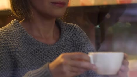 Attractive-female-drinking-tea,-resting-in-cafeteria,-work-break,-urban-relax