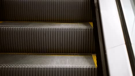 Escalator.-Steps-with-a-yellow-escalator