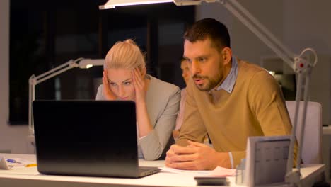 business-team-with-laptop-working-at-night-office