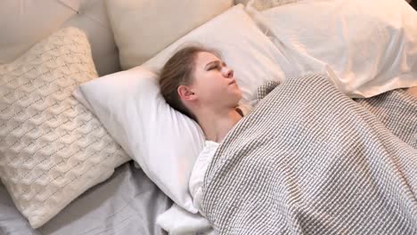 Top-View-of-Disturbed-Young-Girl-Trying-to-Sleep-in-Bed