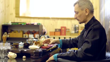 Tea-ceremony.-Master-man-drinking-tea-from-a-white-mug