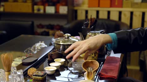 Tea-ceremony.-Tea-maker-pours-boiling-water-into-the-teapot