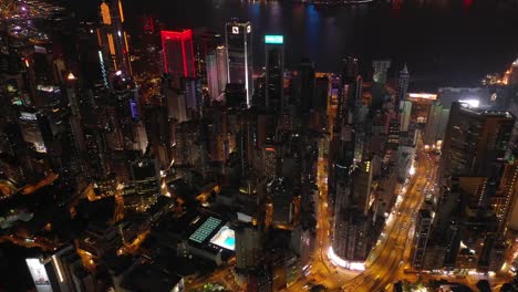 night-time-illuminated-hong-kong-cityscape-downtown-traffic-street-topdown-aerial-panorama-4k