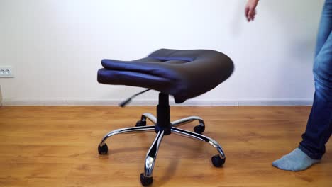 man-assembling-office-chair-at-home
