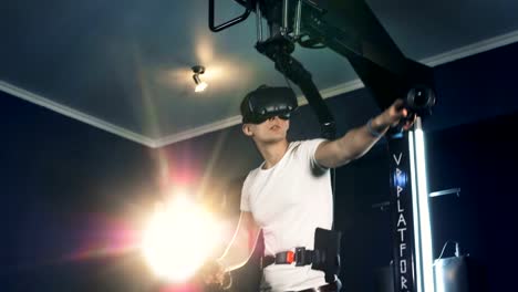 One-man-moving-hands,-playing-VR-games.-Robotic-VR-cybernetic-gaming-system.