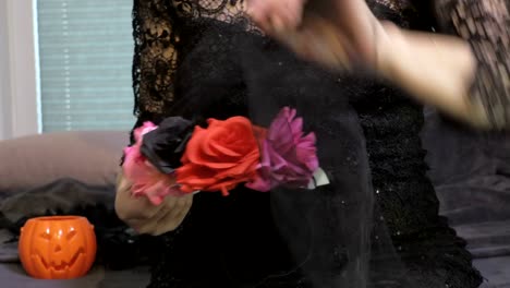 Woman-sitting-and-holding-Halloween,Day-of-the-Dead-mask