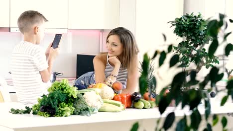 Mobile-phone.-The-son-takes-a-photo-portrait-of-mom-on-a-cell-phone.