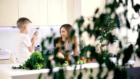 Mobile-phone.-The-son-takes-a-photo-portrait-of-mom-on-a-cell-phone.