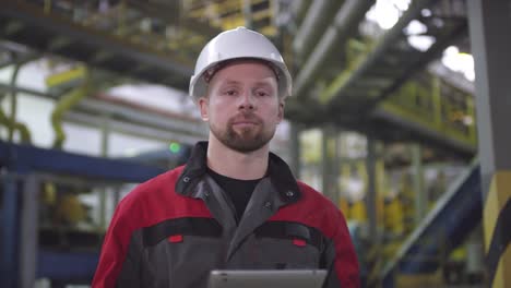 Proud-Male-Factory-Operator-Posing-in-front-of-Automated-Production-Line