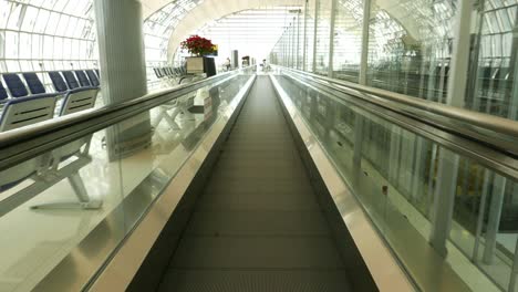 Sliding-airport-travelator.-Walking-fast-on-moving-walkway.-Subjective-view,-slow-motion..