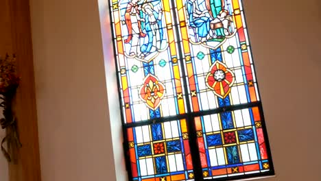 Camera-pans-across-stained-glass-windows-in-a-church