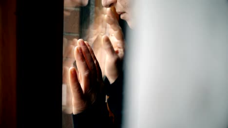 Desperate-sad-woman's-hands--on-window,-close-up