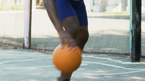 Athlete-playing-basketball,-dribbling-ball-skillfully-to-bypass-opponent,-sports