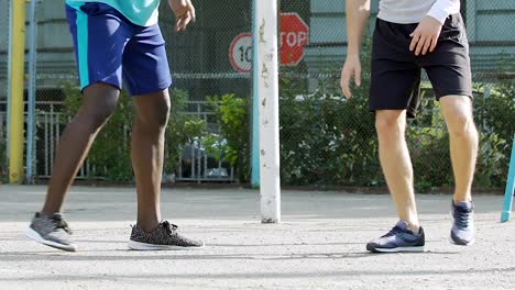 Black-and-white-men-playing-basketball-outside-summer,-dribbling,-competition