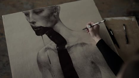 Close-up-of-womans-hand-painting-in-her-studio