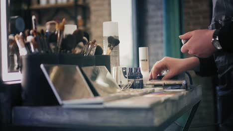 Brush-sets-and-shadow-palettes-for-make-up-on-the-table-in-beauty-salon